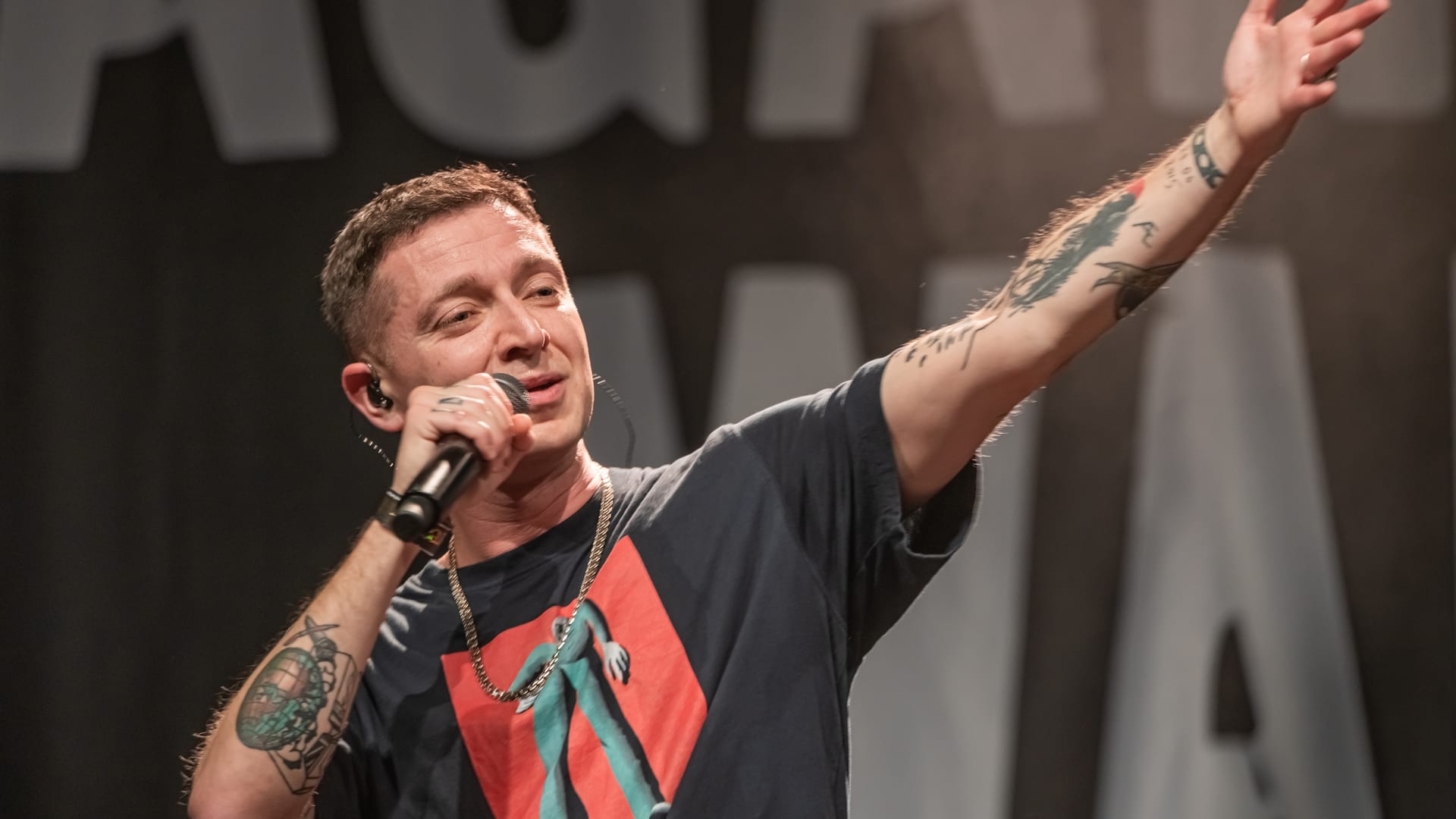 Oxxxymiron на сцене с микрофоном — концерт «Russians Against War» в Берлине, 2022 (фото A.Savin)